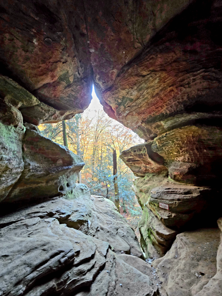 Hocking Hills State Park trail with sandstone cliffs and cave-like rock formations in Ohio